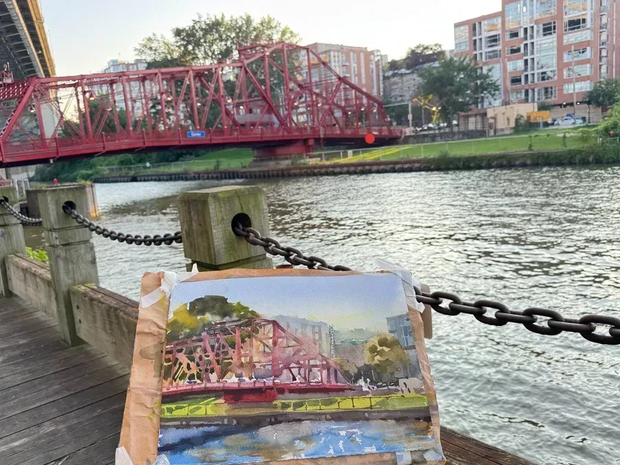 View of both painting and the actual scene of the Center Street Swing Bridge and the Cuyahoga River.